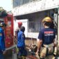 Petugas pemadam kebakaran masih melakukan pendinginan setelah api  yang membakar rumah dua lantai di Desa Karangjompo berhasil dijinakkan, Selasa (18/8/26).
